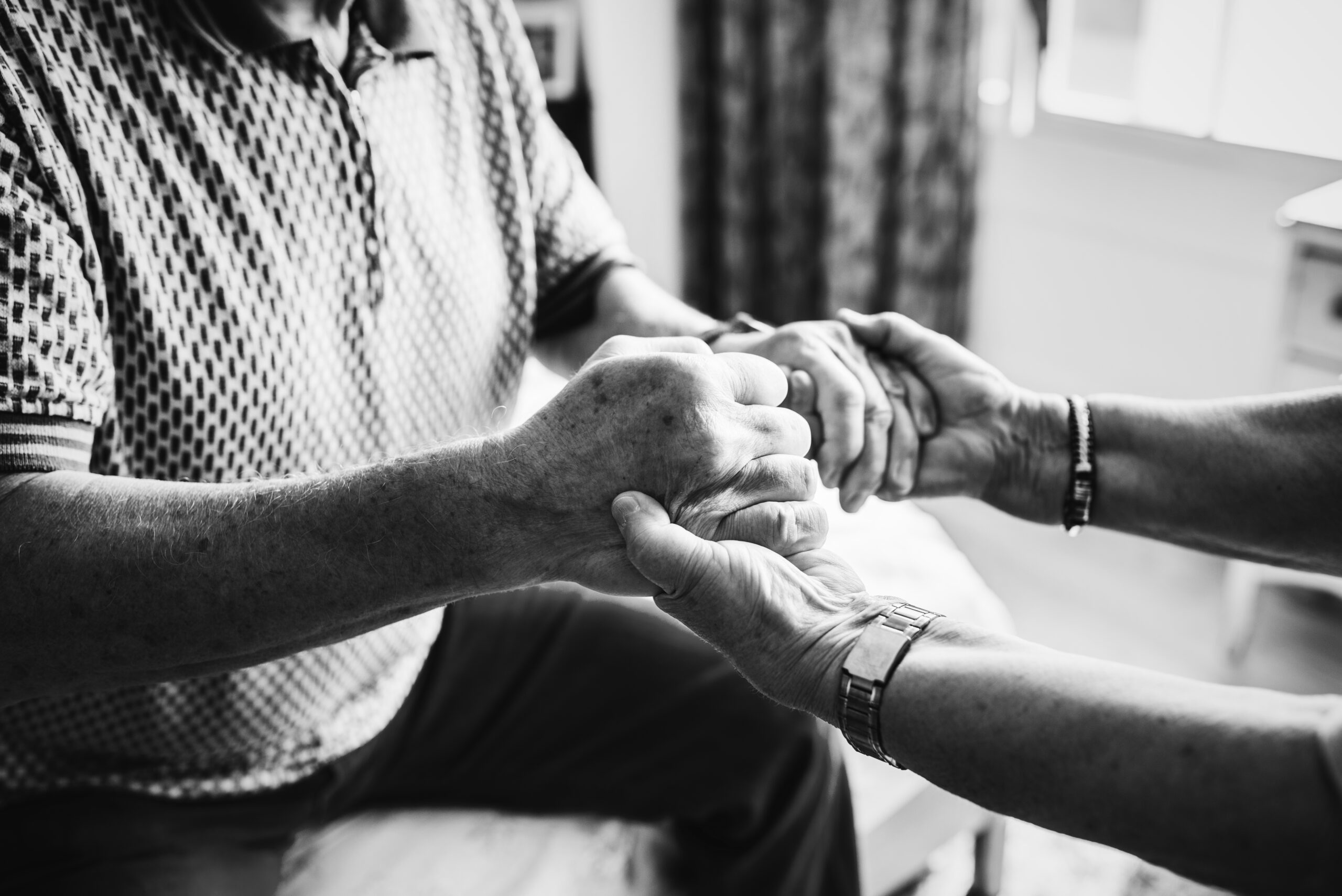 Senior couple holding hands