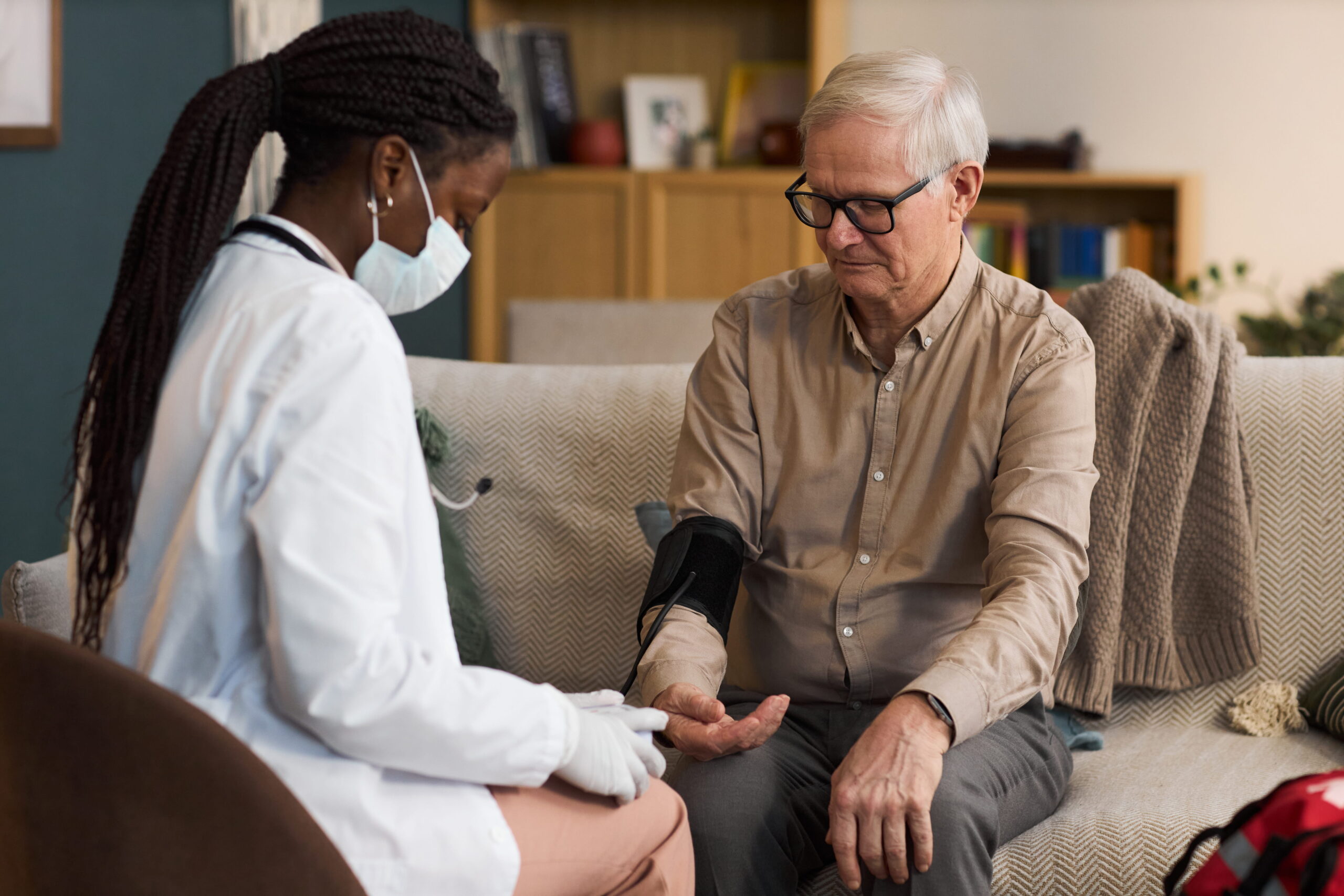 Black female doctor blood pressure BP check man